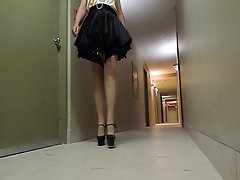 Sissy Ray in hotel corridor wearing maids uniform