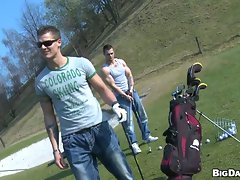 Muscular handsome studs tease each other in the golf course