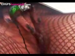 Short-haired chick in fishnets gets naked and masturbates