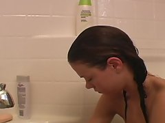 Teen takes a bath and rubs lotion on legs