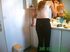 Cute redhead is caught on hidden camera dressing in bathroom