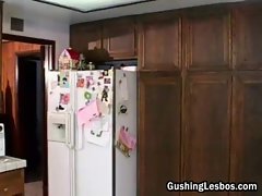 Lesbian dildo fucking in the kitchen
